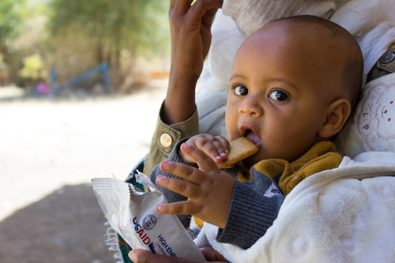 Natan Hailay eating from the High energy biscuit donation (Image source: UNICEF Ethiopia)